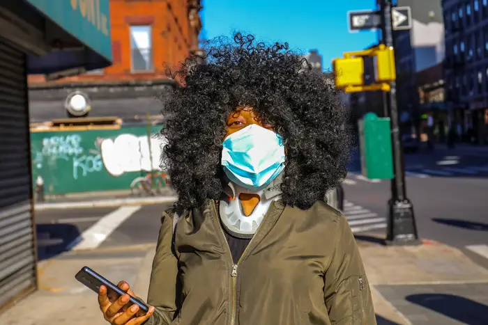 A woman wearing a blue surgical mask